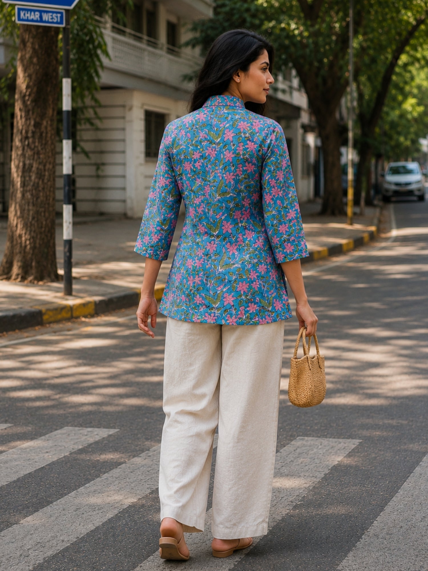 Woman wearing Aster Blue Cotton Top styled with beige linen pants, showcasing breathable cotton fabric and floral print design