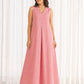 Full length front shot of peach sleeveless handloom ikat maxi dress styled on model in outdoor setting.