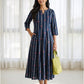 Woman wearing a navy blue floral printed cotton dress with three-quarter sleeves and a flowing Kalidaar silhouette.