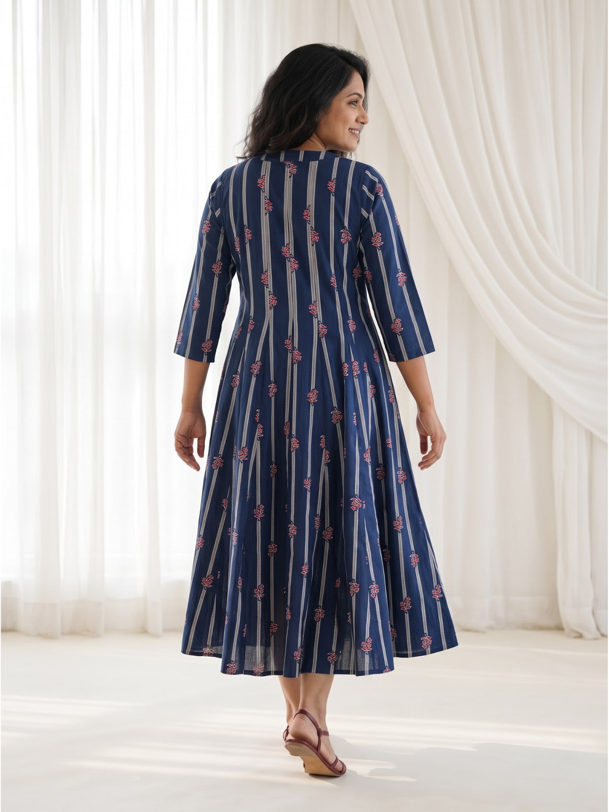 Back view of Mehr Navy Cotton Kalidaar Dress showing continuous shoulder-to-hem panels, vertical stripes and a graceful flared silhouette.