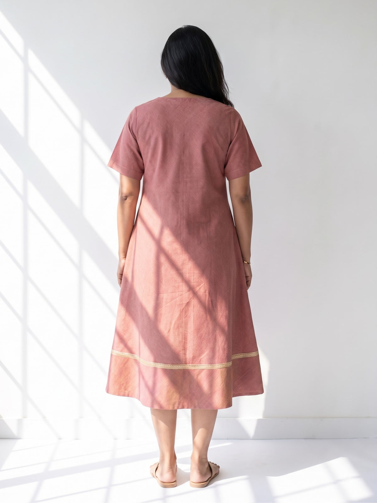Aarika Rosewood Ikat cotton dress for women twirl pose highlighting the flared hem and movement