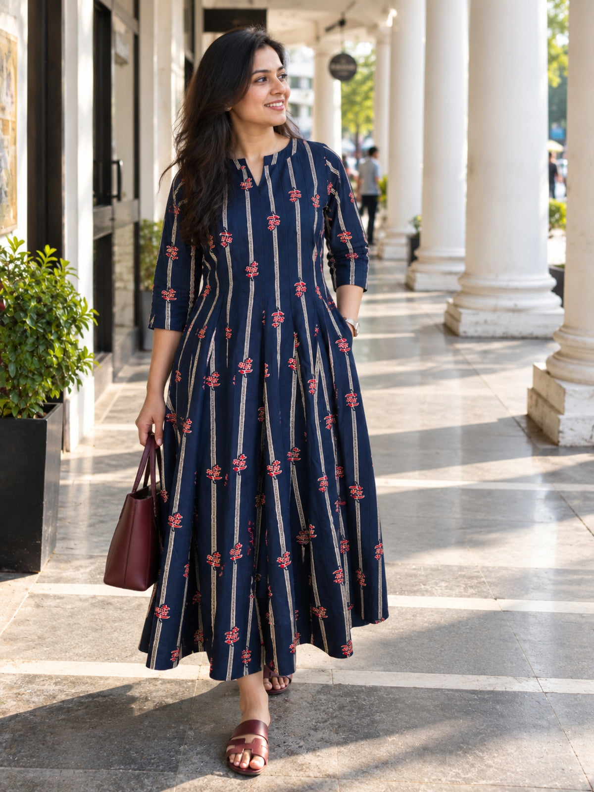 Darzaania Mehr Navy Blue Cotton Kalidaar Dress featuring delicate red floral motifs, vertical stripes and a flowing silhouette