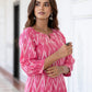 Close-up detail of handloom Ikat fabric on pink kurta set
