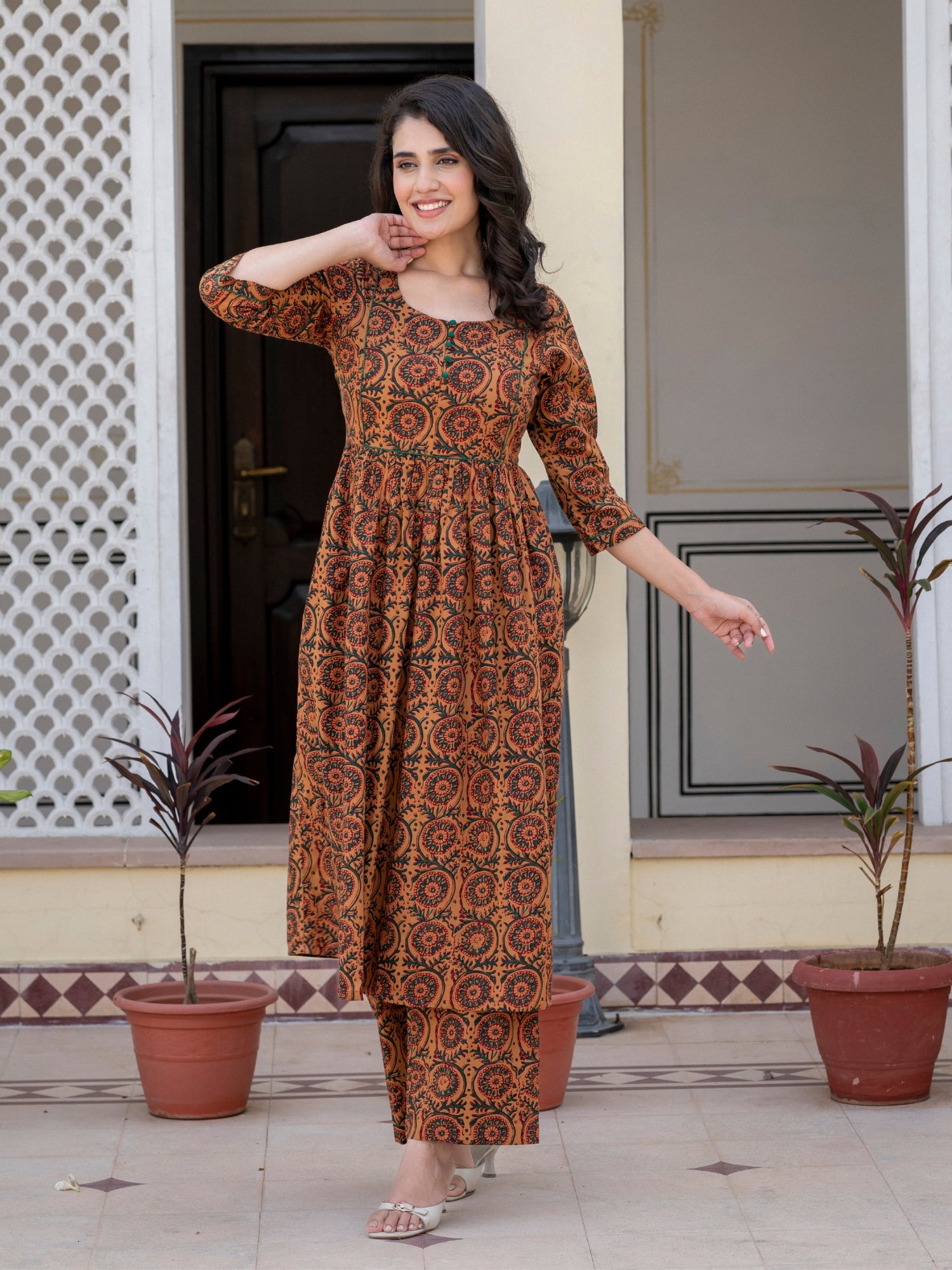Woman wearing Darzaania Nayra brown printed cotton kurta set front view